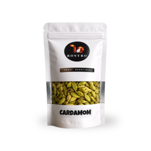 ROSTRO premium green cardamom pouch displayed on a rock with a natural plantation background.